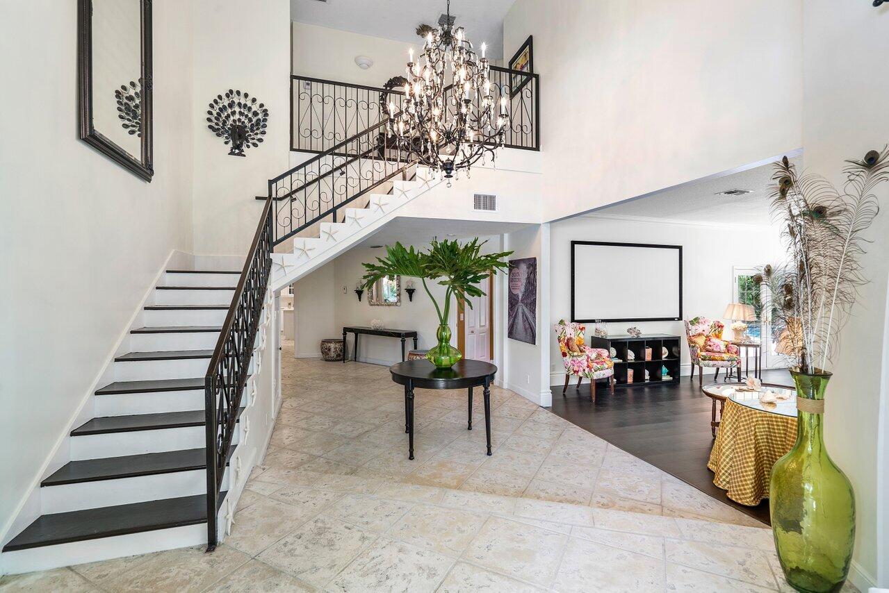 243 Florenada Terrace Boca Raton, FL 33486 - Photo 5 of 48 a view of hall way with furniture and a chandelier