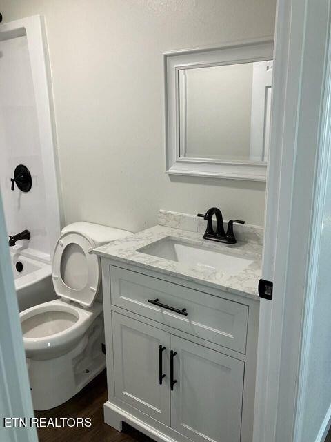 1486 Short Street Morristown, TN 37814 - Photo 12 of 12 a bathroom with a toilet sink and mirror