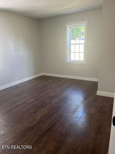 1486 Short Street Morristown, TN 37814 - Photo 9 of 12 an empty room with wooden floor and windows