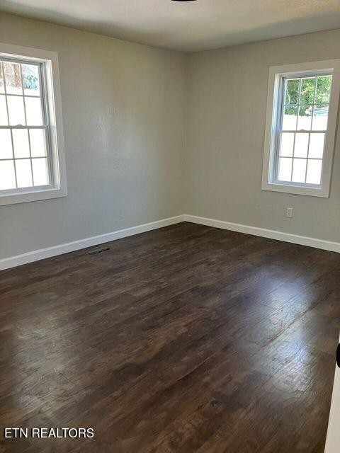 1486 Short Street Morristown, TN 37814 - Photo 10 of 12 an empty room with wooden floor and windows