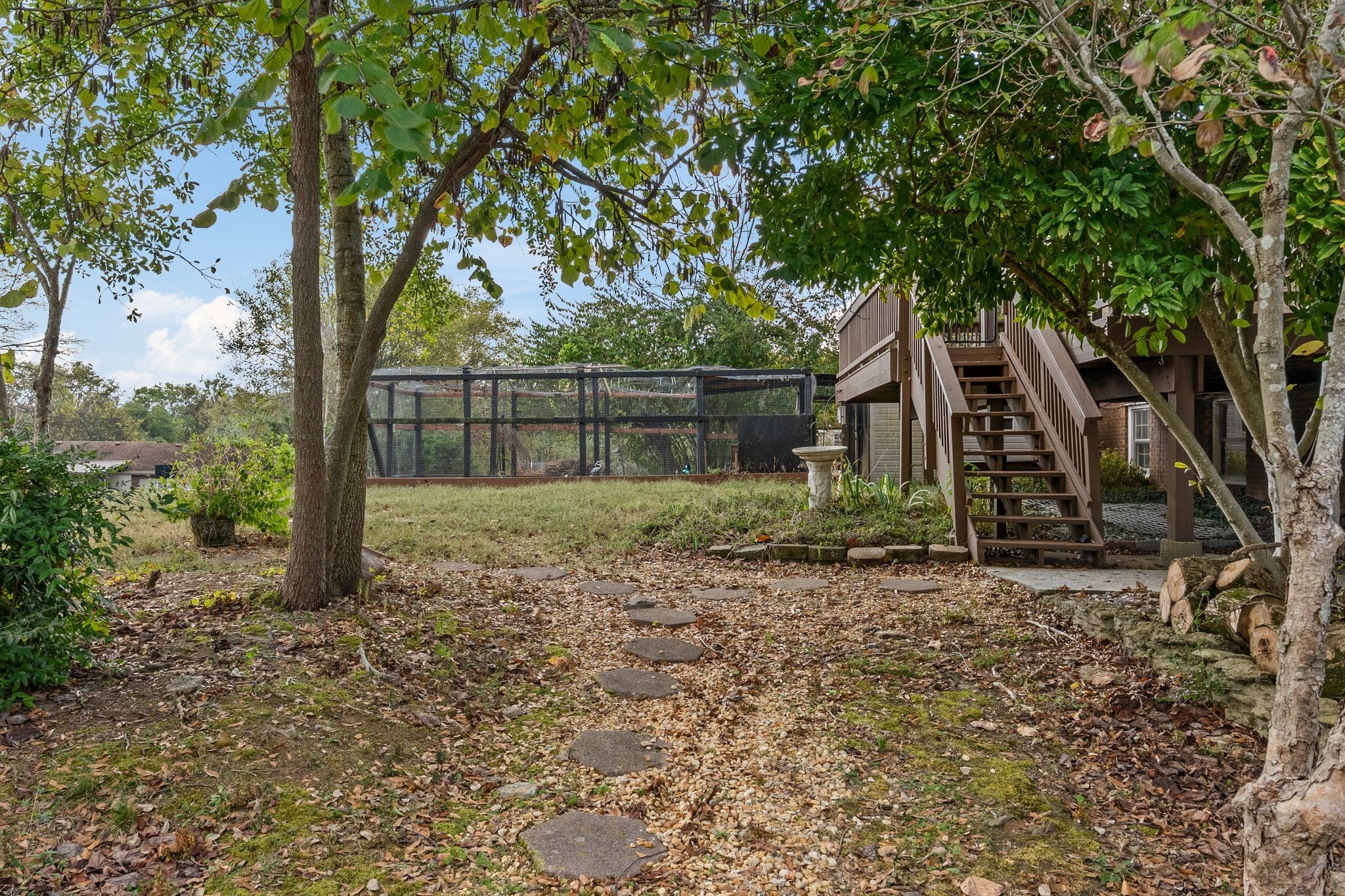 104 Meadowvue Drive Hendersonville, TN 37075 - Photo 37 of 43 a backyard of a house with lots of plants and large trees