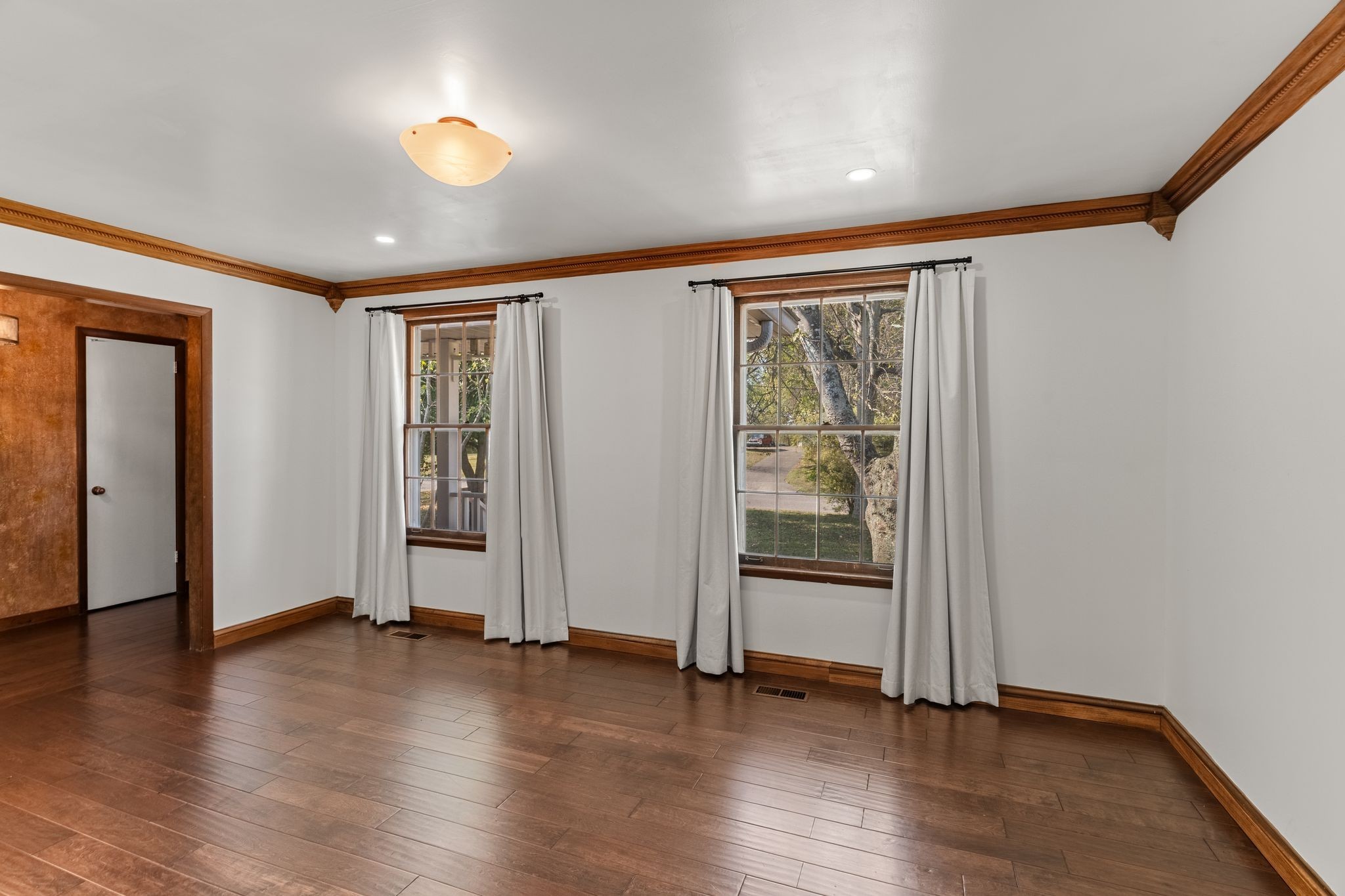 104 Meadowvue Drive Hendersonville, TN 37075 - Photo 9 of 43 an empty room with wooden floor and windows