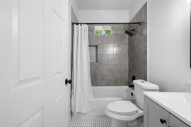 a bathroom with a toilet and shower