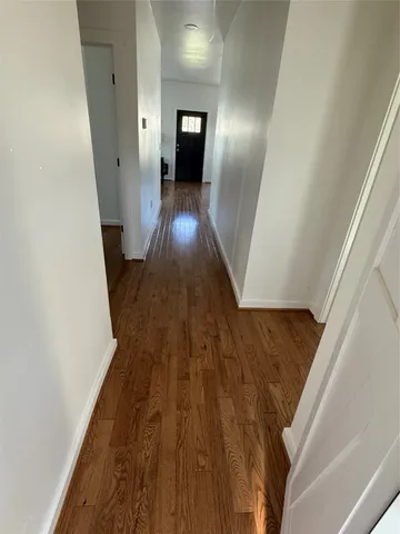 a view of a hallway view with wooden floor