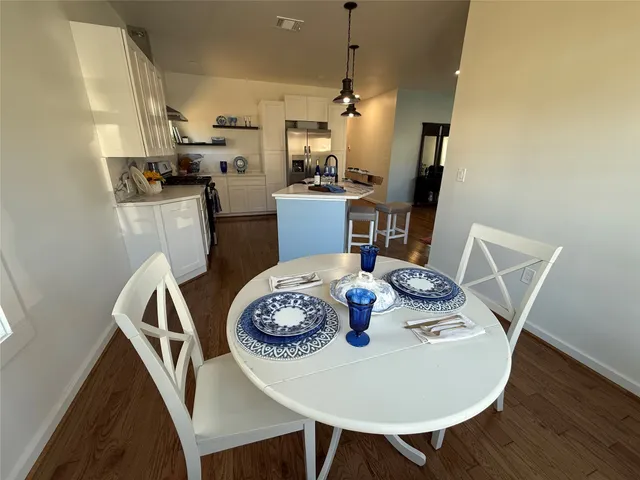 a view of a dining room with furniture and wooden floor