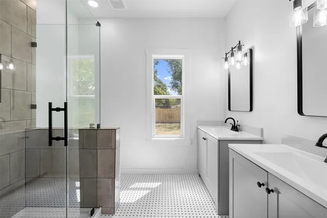 a bathroom with a sink a toilet and shower