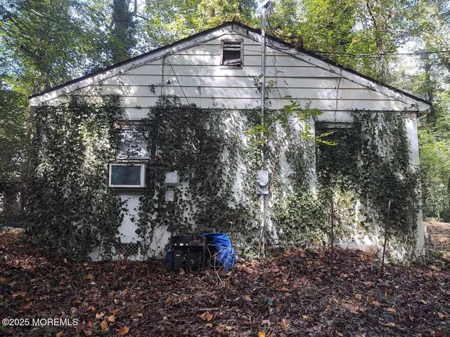 a backyard of a house with lots of plants and trees