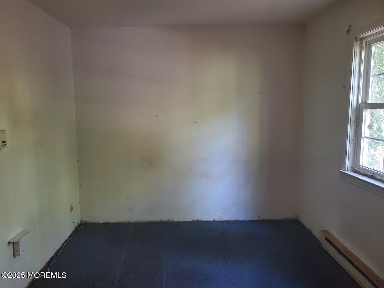 119 A Brindletown Road Cookstown, NJ 08533 - Photo 8 of 12 an empty room with wooden floor and windows