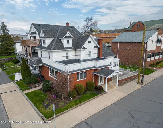 an aerial view of a house with a yard