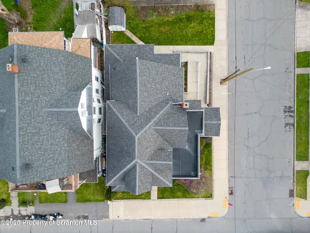 aerial view of a house with a yard and potted plants