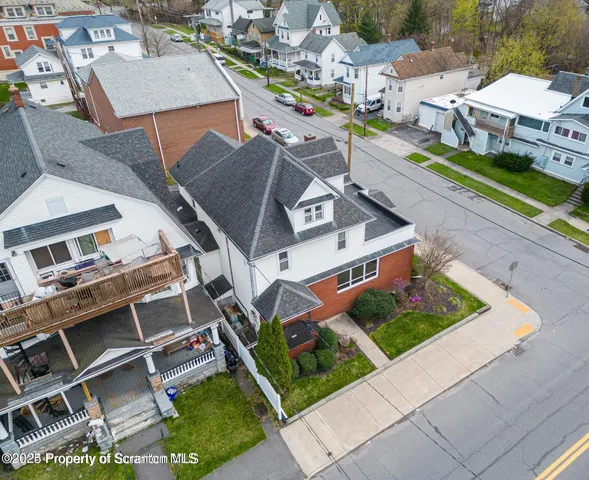 an aerial view of a house with a garden and trees