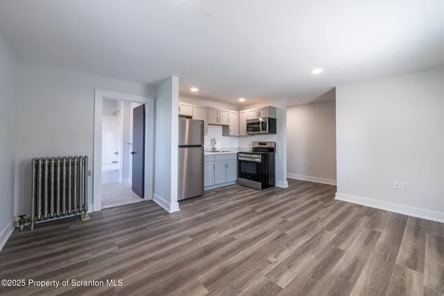 a view of a kitchen with a stove cabinets and wooden floor