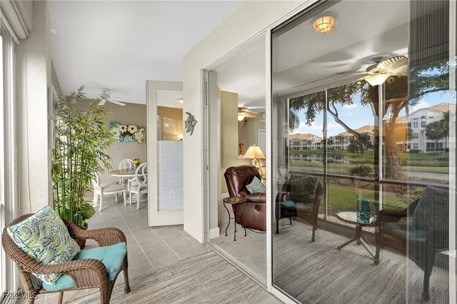 a balcony with furniture and a potted plant