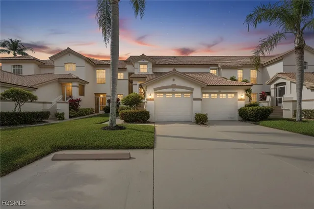 a front view of a house with a garden and plants