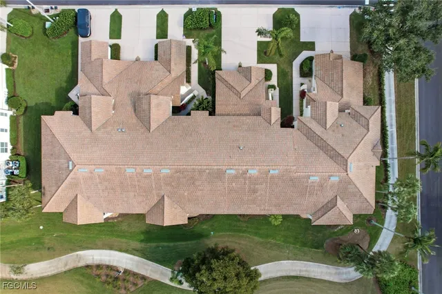 an aerial view of a house with garden space and lake view