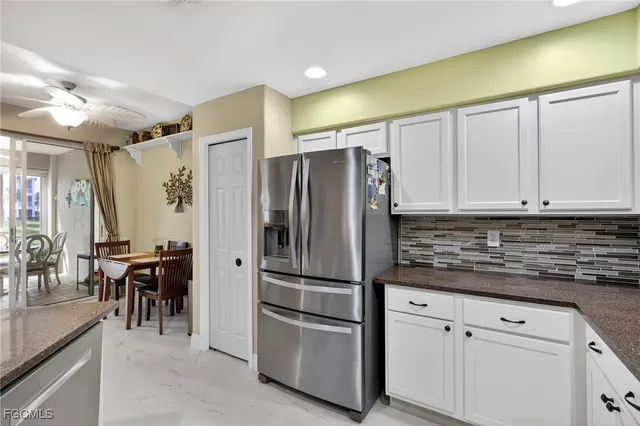 a kitchen with stainless steel appliances granite countertop a refrigerator and a stove top oven