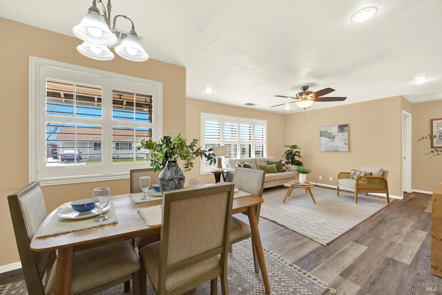112 East Kentucky Street Fairfield, CA 94533 - Photo 22 of 70 a dining room with wooden floor a chandelier a wooden table and chairs