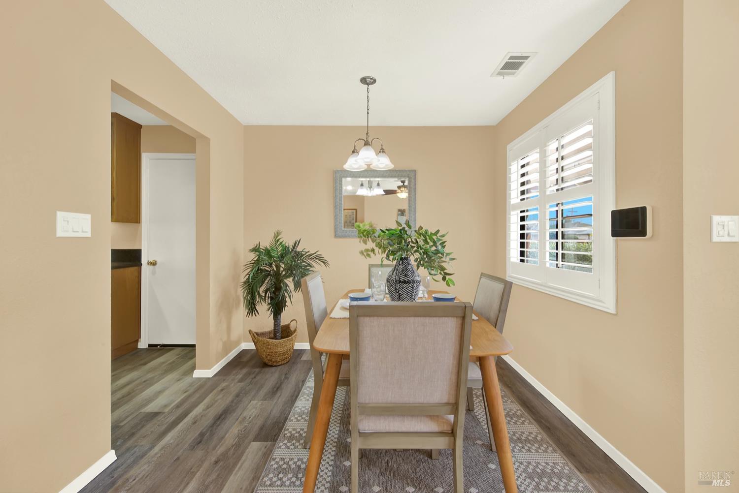 112 East Kentucky Street Fairfield, CA 94533 - Photo 3 of 70 a dining room with furniture potted plants and wooden floor