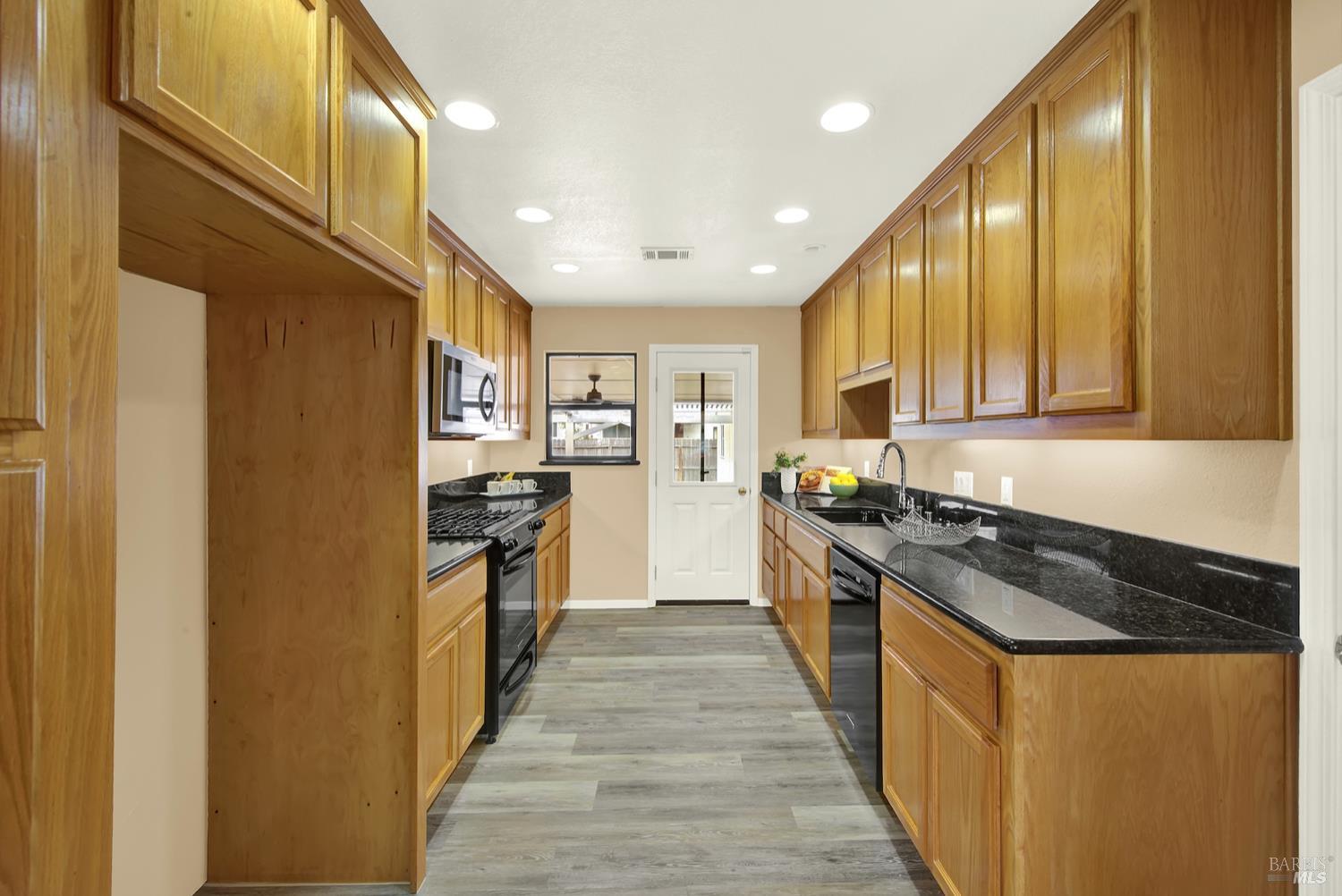 112 East Kentucky Street Fairfield, CA 94533 - Photo 4 of 70 a large kitchen with stainless steel appliances granite countertop a stove and a refrigerator