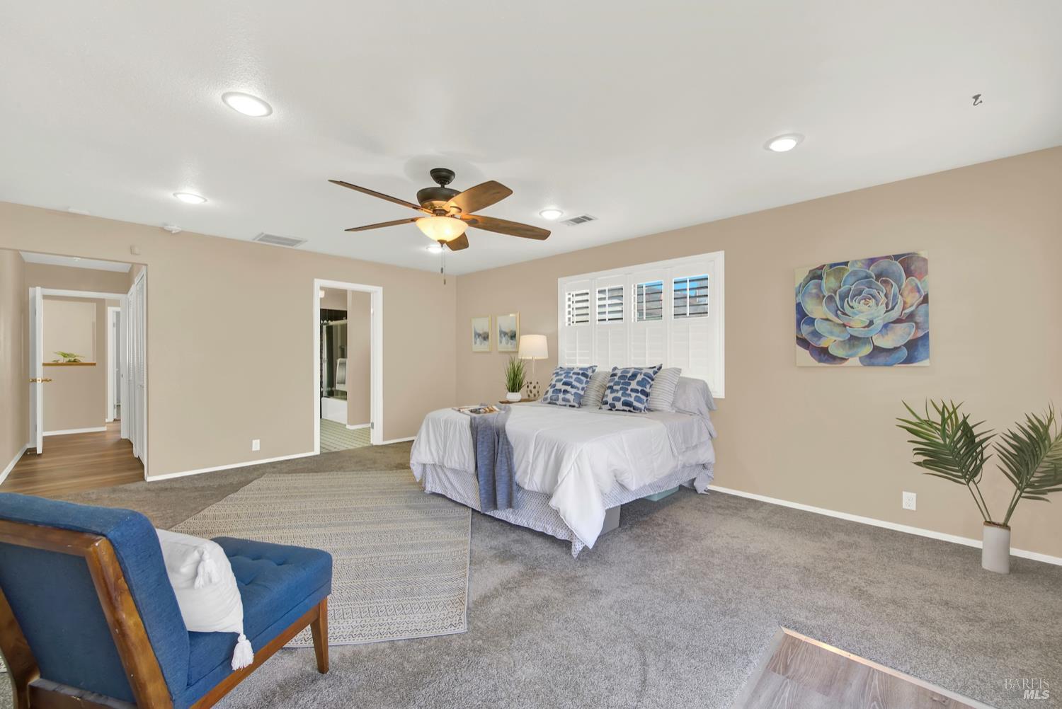 112 East Kentucky Street Fairfield, CA 94533 - Photo 42 of 70 a spacious bedroom with a bed and a chandelier