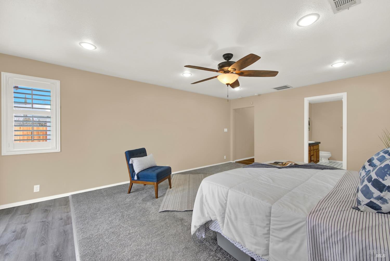 112 East Kentucky Street Fairfield, CA 94533 - Photo 43 of 70 a bedroom with a bed and a chandelier