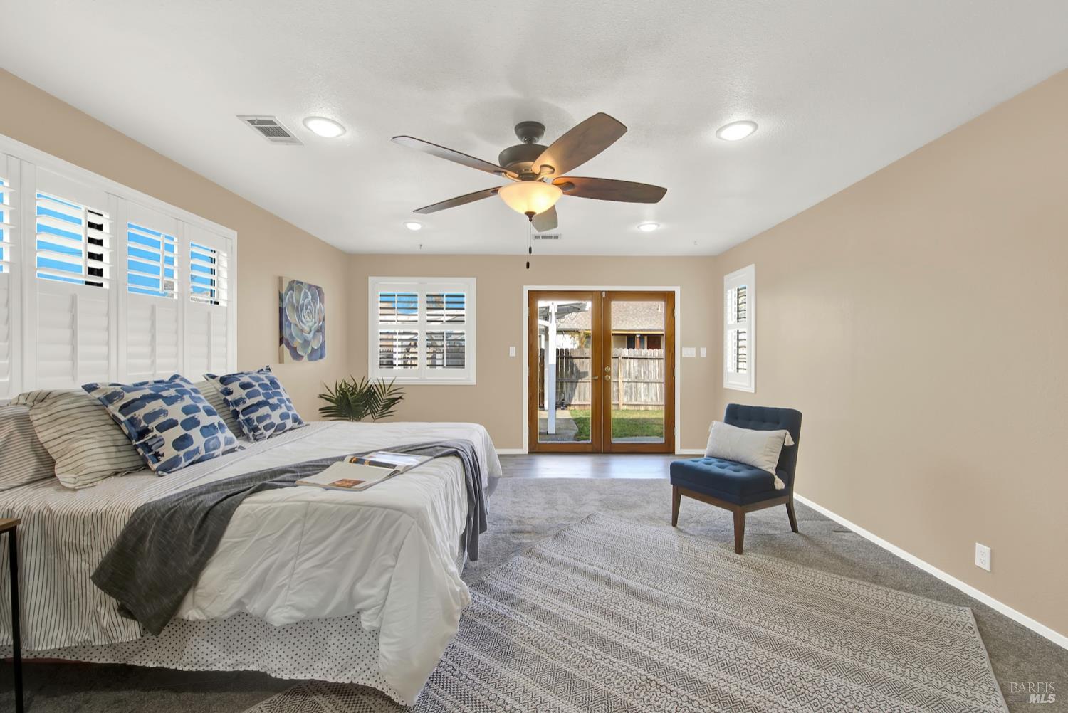 112 East Kentucky Street Fairfield, CA 94533 - Photo 5 of 70 a bedroom with a bed and a chandelier