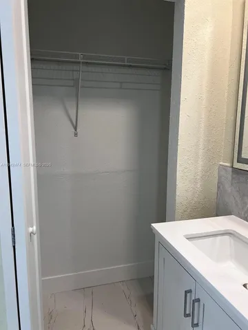 a bathroom with a sink and shower