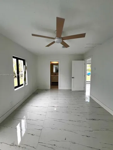 a view of an empty room with a window