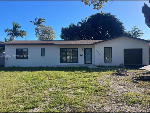a house that has a tree in front of it