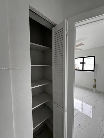 a view of an empty room with a closet