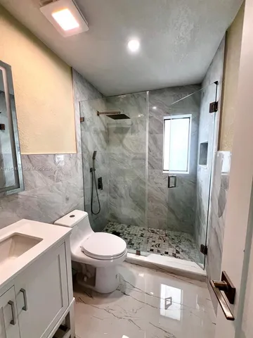 a bathroom with a sink toilet and shower