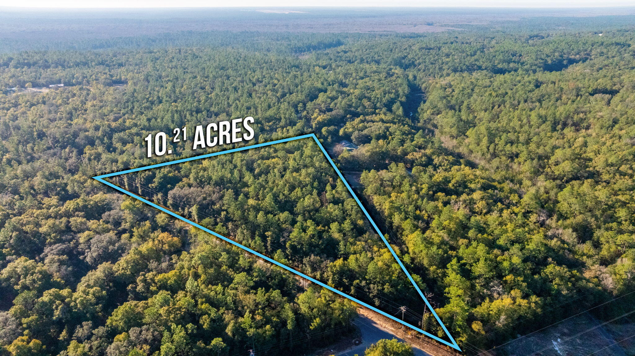 10-ac Broxson Road Holt, FL 32564 - Photo 2 of 4 an aerial view of residential house and outdoor space