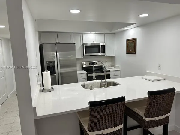 a kitchen with a dining table and chairs