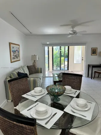 a living room with furniture two window and a table