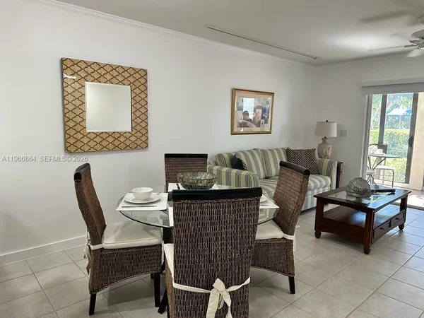 a living room with furniture a rug and a window