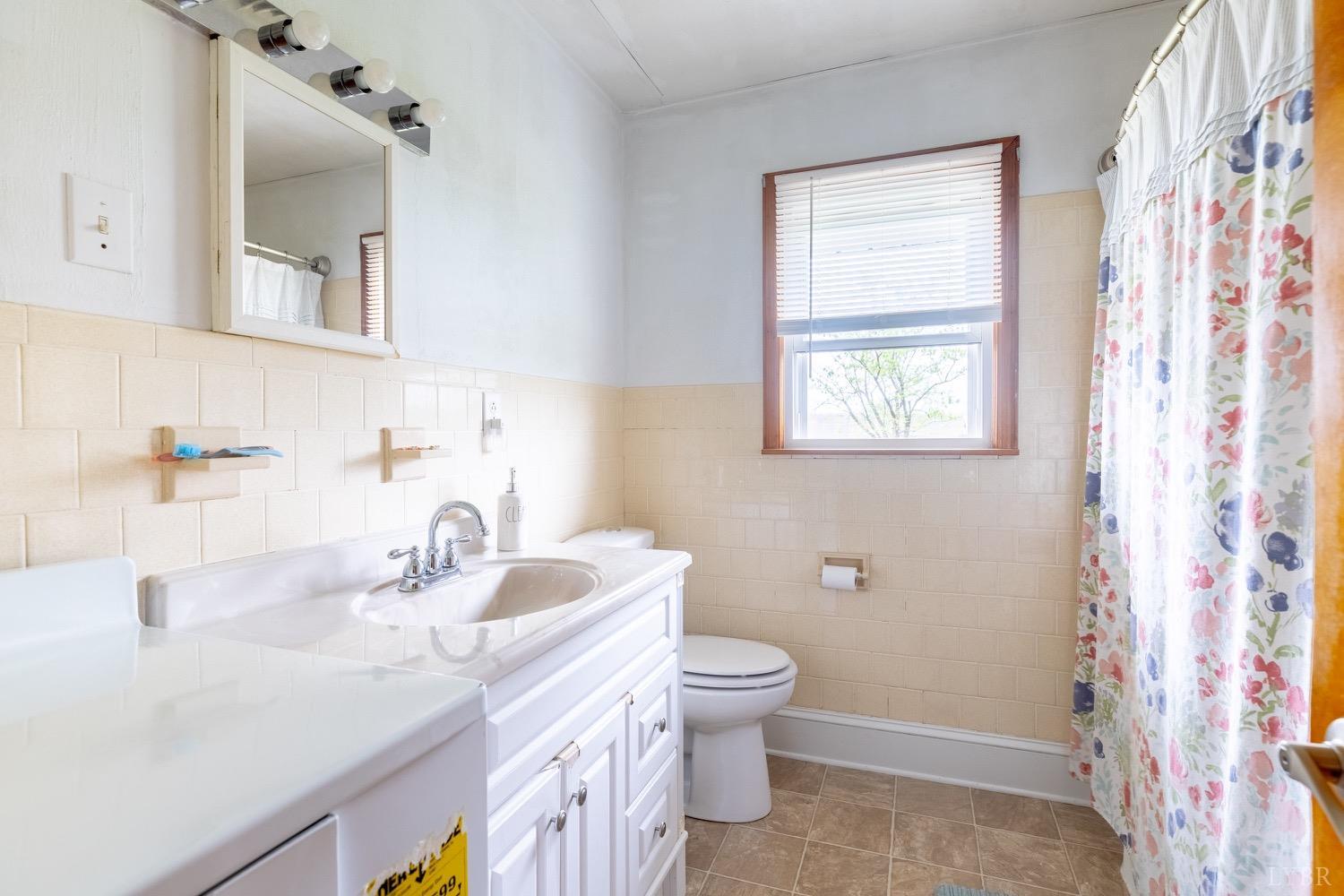 4100 Roark Mill Road Hurt, VA 24563 - Photo 16 of 42 a bathroom with a toilet sink and mirror