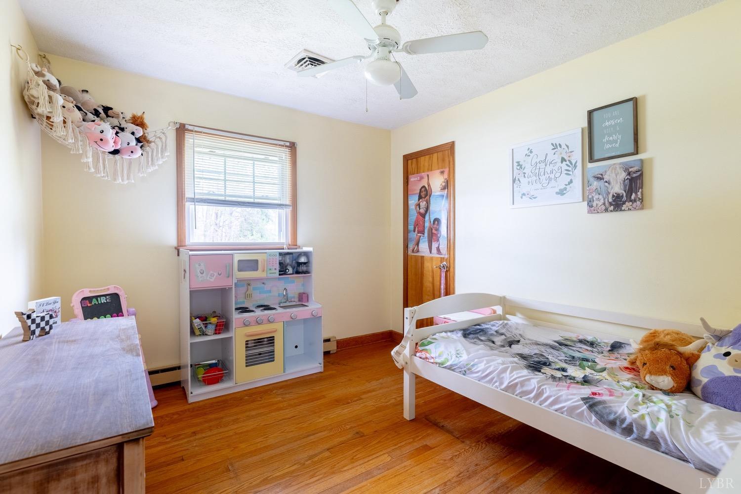 4100 Roark Mill Road Hurt, VA 24563 - Photo 19 of 42 a bedroom with a bed and wooden floor