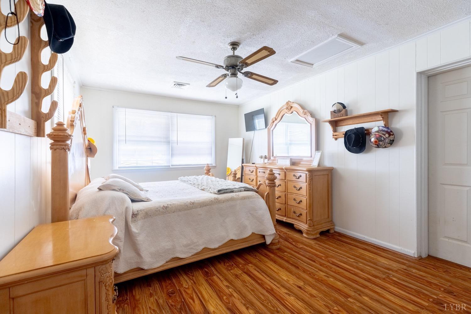 4100 Roark Mill Road Hurt, VA 24563 - Photo 10 of 42 a bedroom with a bed and wooden floor