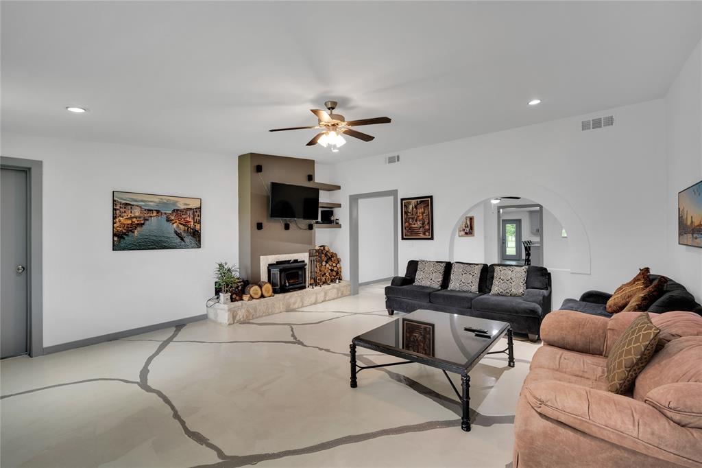 10476 County Road 313 Terrell, TX 75161 - Photo 5 of 40 a living room with furniture a fireplace and a flat screen tv