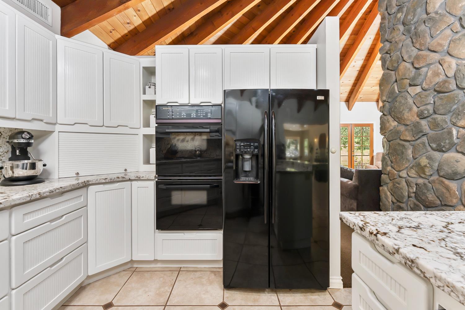 5990 Upper Ridge Way Auburn, CA 95602 - Photo 11 of 51 a kitchen with a refrigerator sink and cabinets