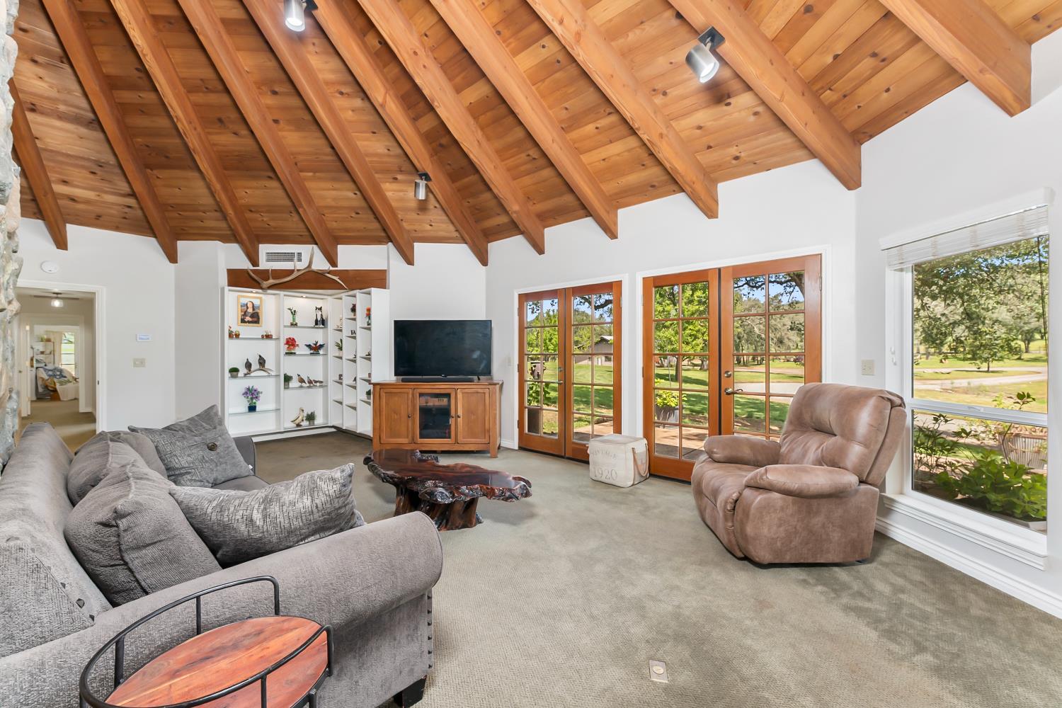 5990 Upper Ridge Way Auburn, CA 95602 - Photo 16 of 51 a living room with furniture a flat screen tv and a large window