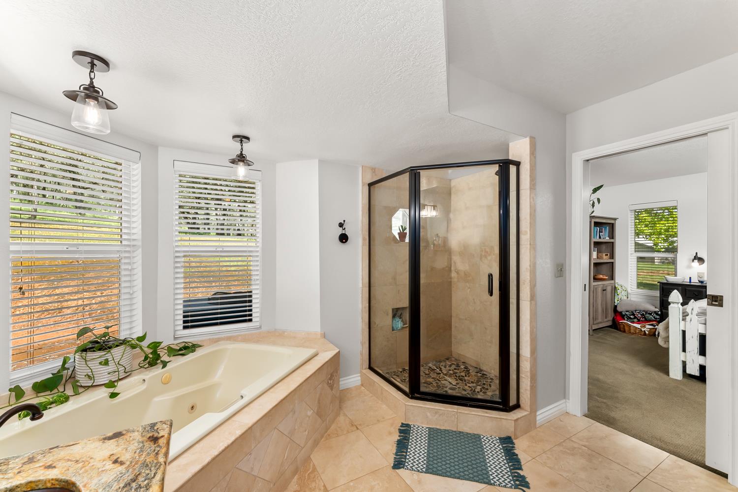 5990 Upper Ridge Way Auburn, CA 95602 - Photo 24 of 51 a spacious bathroom with a tub shower and windows