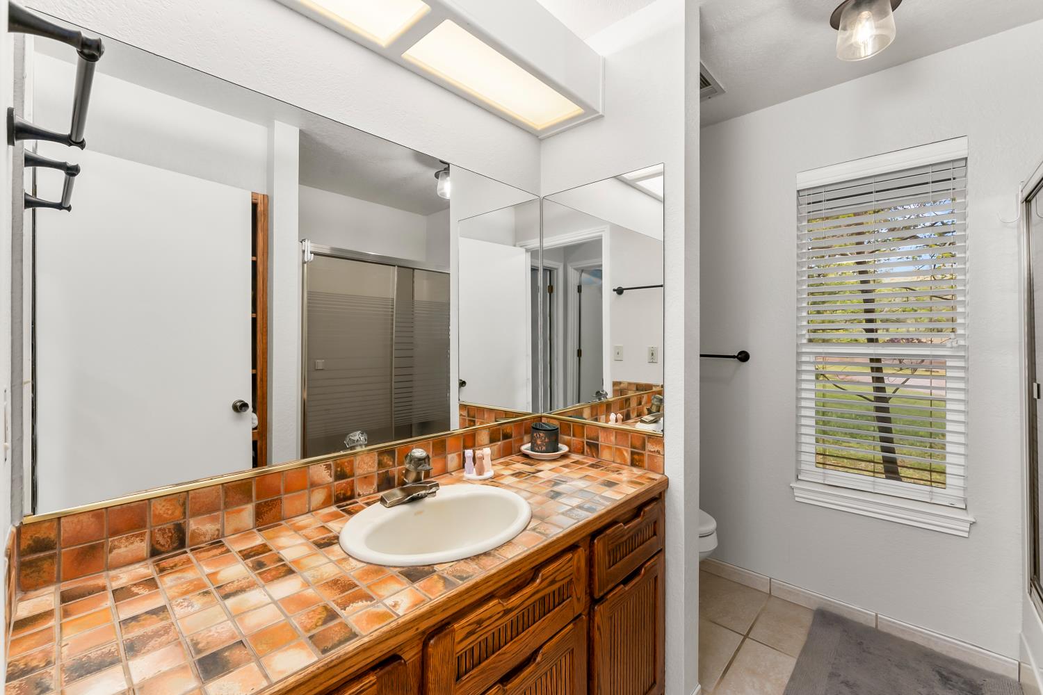 5990 Upper Ridge Way Auburn, CA 95602 - Photo 29 of 51 a bathroom with a granite countertop sink and a mirror