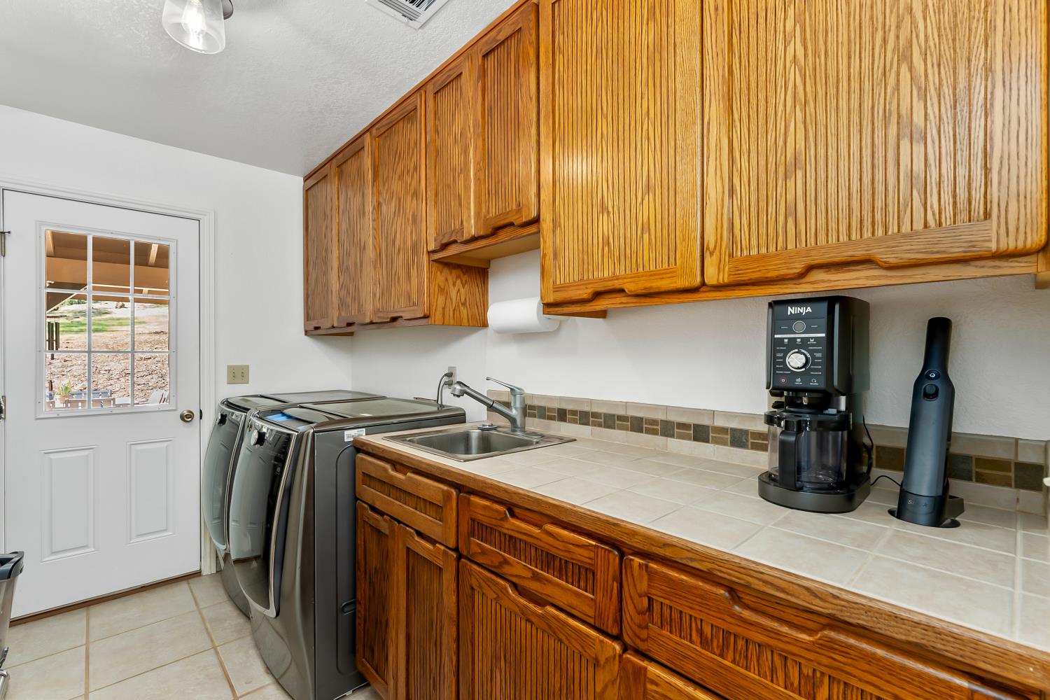 5990 Upper Ridge Way Auburn, CA 95602 - Photo 30 of 51 a kitchen with stainless steel appliances granite countertop a sink a stove and a refrigerator