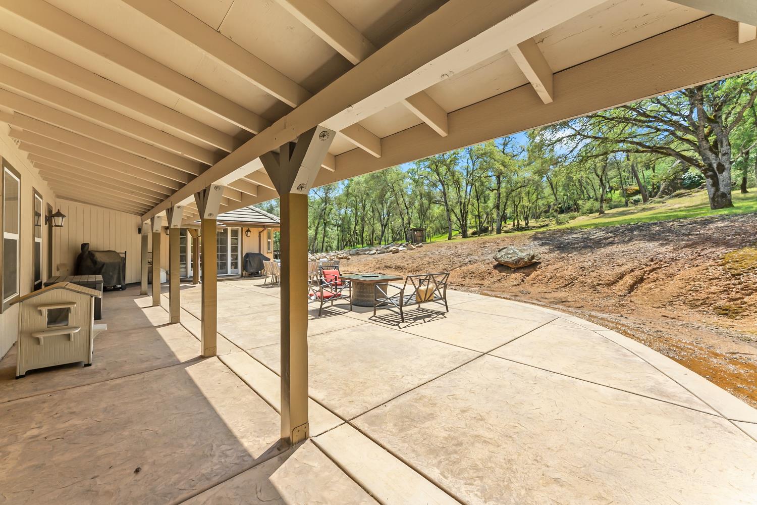 5990 Upper Ridge Way Auburn, CA 95602 - Photo 33 of 51 a view of a porch with furniture and a yard