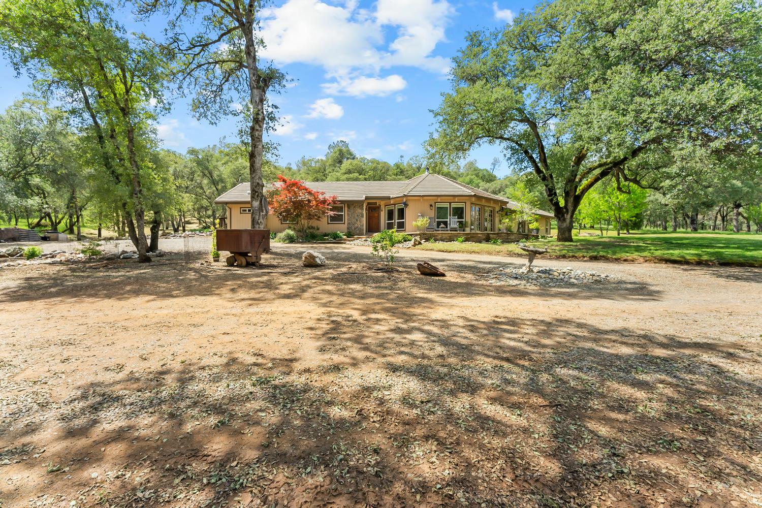5990 Upper Ridge Way Auburn, CA 95602 - Photo 6 of 51 a front view of a house with a yard and large trees