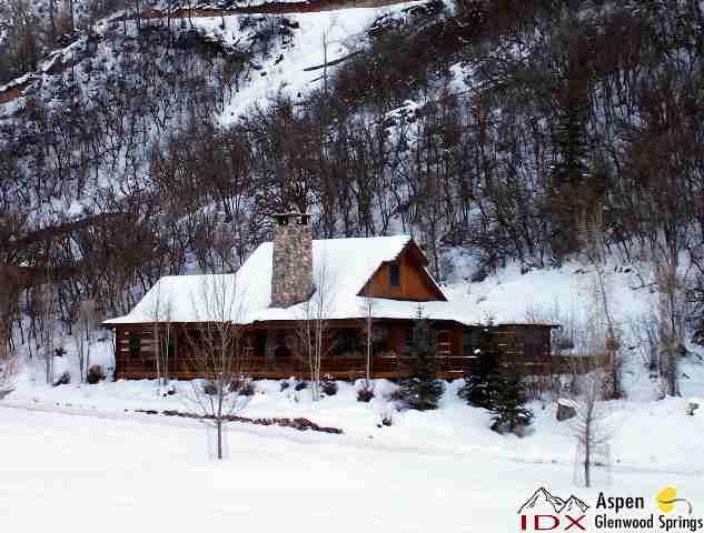 a view of a house with snow on the road