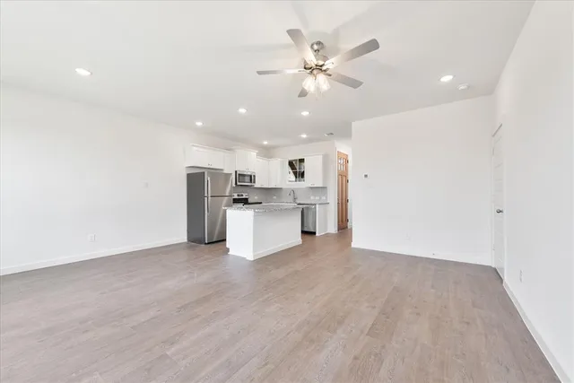 a view of a kitchen with a sink cabinets and wooden floor