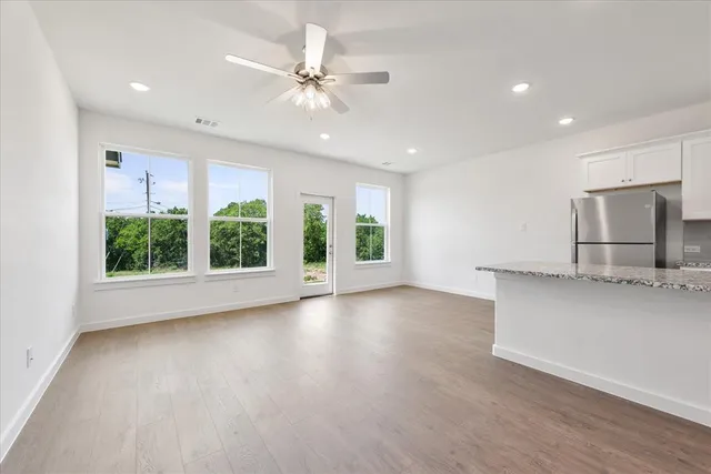 a view of a kitchen with a sink and microwave
