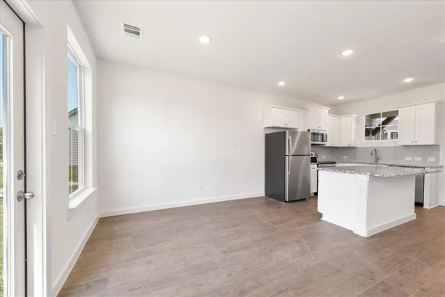 a kitchen with refrigerator and cabinets